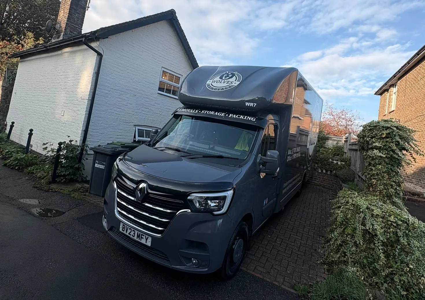 Wolves Removals Luton van on the drive of a white cottage in Cuckfield before a move to Horsham