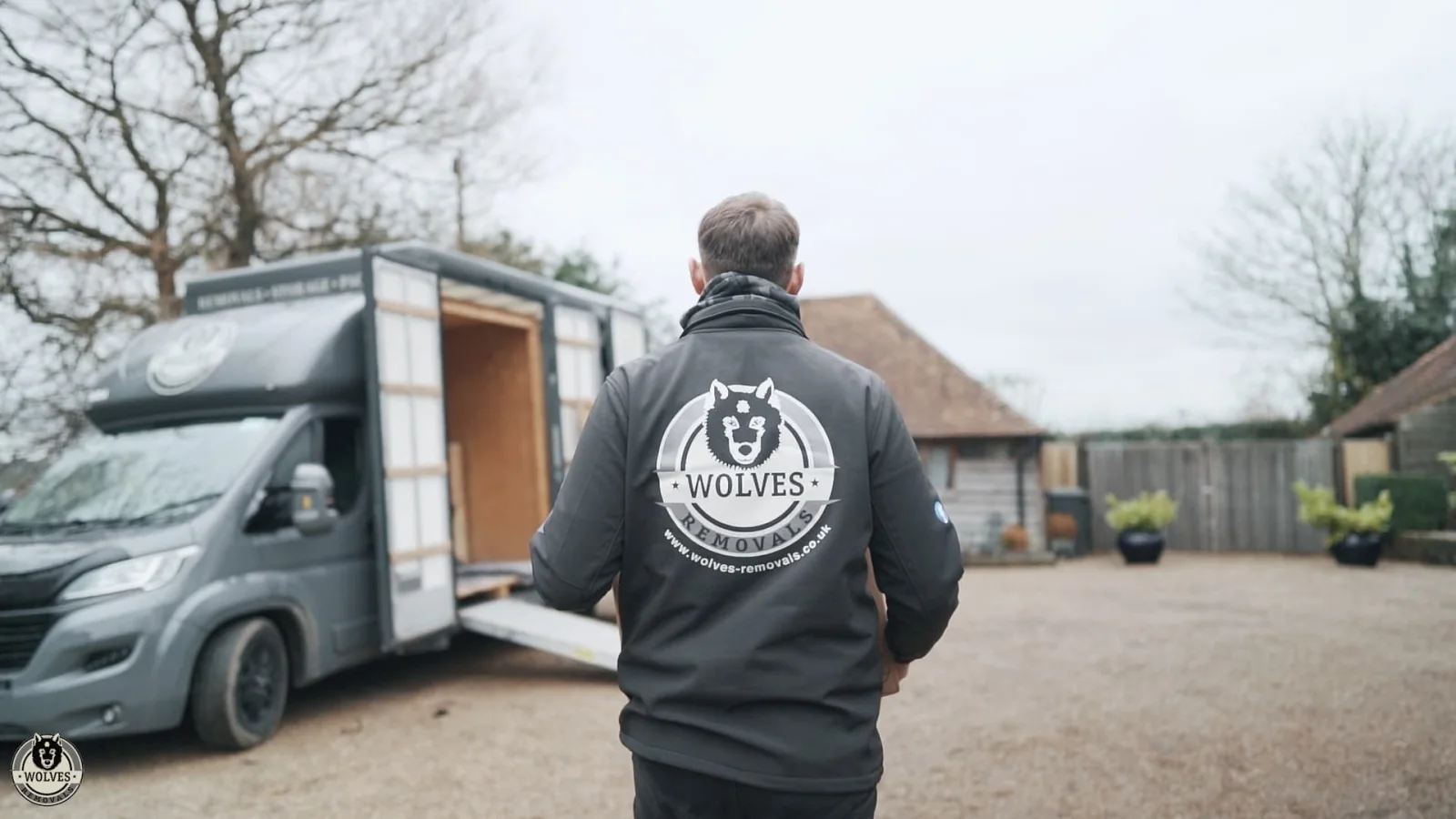 Wolves Removals crew member in branded workwear walking to a branded van with the ramp down